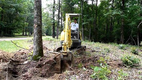 how to knock down pine trees with mini excavator|mini excavators for tree removal.